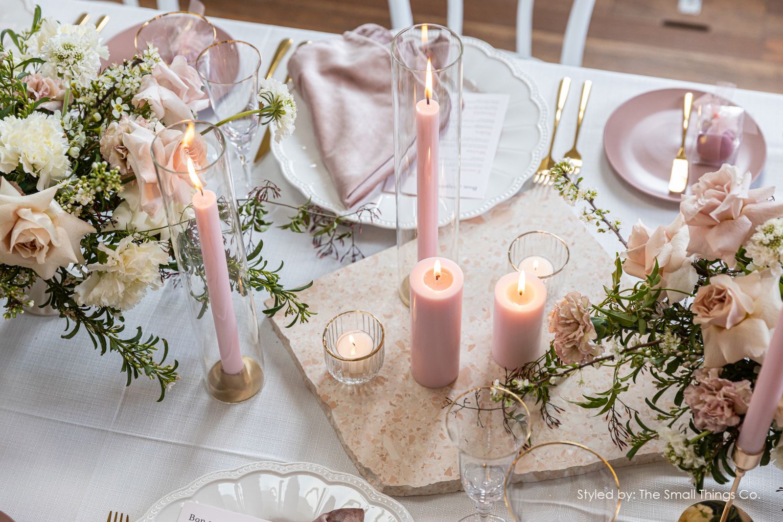 Image of pink wedding table with candles and flowers